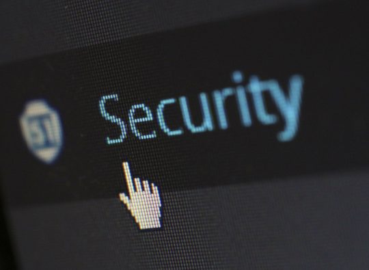 Cursor hovering over a digital 'Security' button, encapsulating the focus on 'cyber security risk assessments' from Islands Insurance.